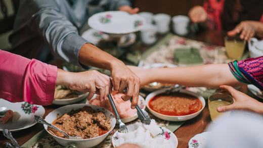 close up of a family at a table celebrating EID
