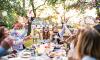 Wedding party celebrates al fresco at a summer garden reception.